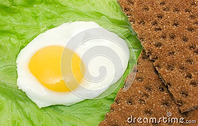 Healthy food background: fried eggs, lettuce, crisp bread Stock Photo