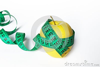 Healthy food concept - fresh fruits and measuring tape, apples and weight loss on a white background. Stock Photo