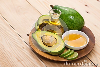 Healthy food concept. Fresh organic avocado oil with honey on ta Stock Photo