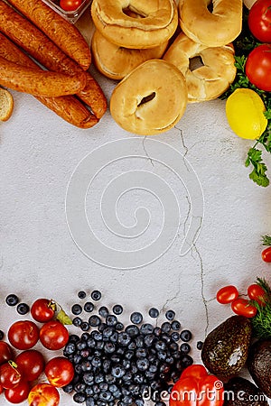 Healthy food concept. Fruits, bagels and sausage on white table Stock Photo