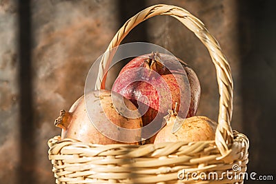 Basket with pomegranates Stock Photo