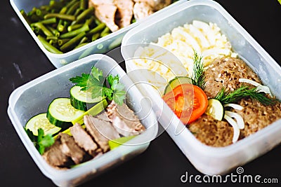 The healthy food in the containers on black background: snack, dinner, lunch. Baked fish, beans, beef cutlets, mashed potatoes, me Stock Photo