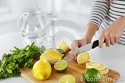 Healthy Food And Eating. Closeup Of Woman Kitchen Cutting Lemons Stock Photo