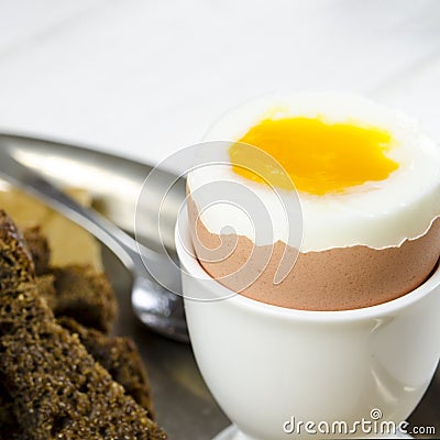 Healthy food. English breakfast with boiled egg and croutons on a white wood background Stock Photo