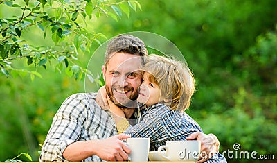 Healthy food. Father and boy drink tea outdoors. Develop healthy eating habits. Feed baby. Natural nutrition concept Stock Photo