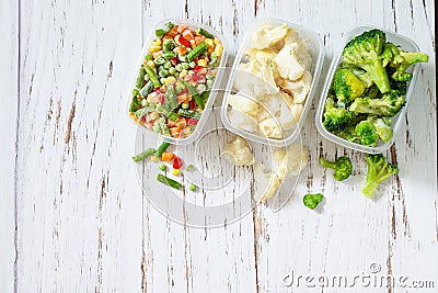 Healthy food is frozen. Stocks of food for the winter. Containers with frozen vegetables. Stock Photo