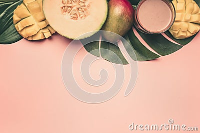 Healthy food, melon, mango and smoothies are laid out on a monstera leaf, on a pink background, space for text flat lay Stock Photo