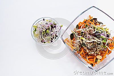 Healthy food - seeds, sprouts and carrots. White background Stock Photo