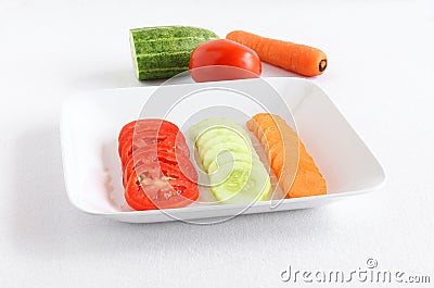 Healthy Food Slices of Tomato, Cucumber and Carrot Stock Photo