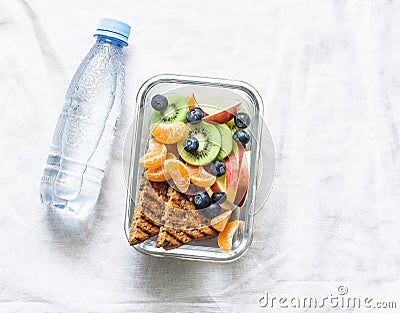 Healthy food snack sweet vitamin lunch box and bottle of clean water on a light background. Peanut butter toast, apples Stock Photo