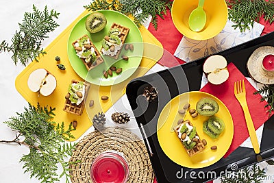 Healthy food. Top view decoration holiday background. Flat lay. Breakfast with waffles, kiwi, almond, soft cheese, apple, milk on Stock Photo