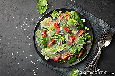 Healthy food. Top view of a fresh green vegetable salad of spinach, tomato, lettuce and sesame seeds Stock Photo