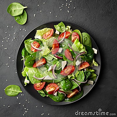 Top view of a fresh green vegetable salad of spinach, tomato, lettuce and sesame seeds Stock Photo
