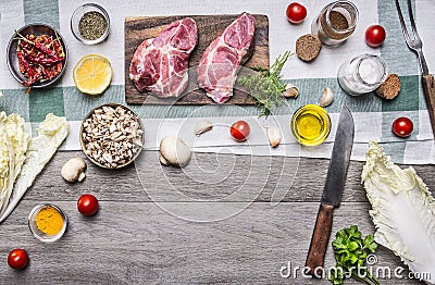 Healthy foods, cooking concept pork steak with vegetables,knife, fruits, spices, laid out frame place for text, on wooden rusti Stock Photo