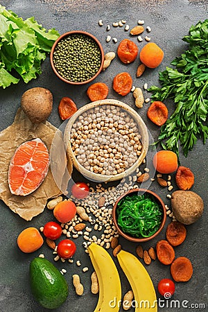 Healthy foods high in potassium. A variety of legumes, salmon, fruits, vegetables, dried apricots, seaweed chuka and nuts on a Stock Photo