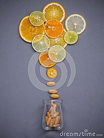 Healthy foods and medicine concept. Bottle of vitamin C and various citrus fruits. Citrus fruits sliced lime,orange and lemon on Stock Photo