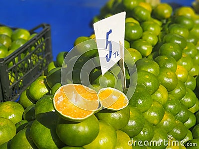Healthy fresh green mandarins on the countertop at local vegetable bazaar Stock Photo