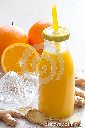 Healthy and fresh orange juice with addition of ginger on white wooden table Stock Photo