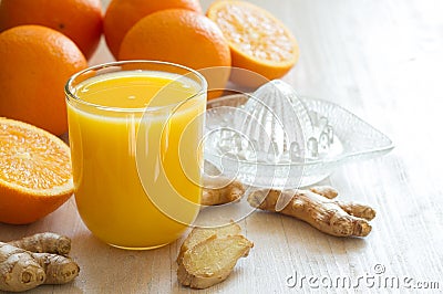 Healthy and fresh orange juice with addition of ginger on white wooden table Stock Photo