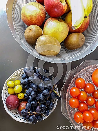 Healthy and fresh various fruit in a bowl on the table top view, grapes, apples, bananas healthy lifestyle Stock Photo