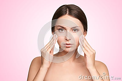 Healthy girl cleaning self mascara. Color lotion wash. Black eyeliner and lipstick cream. Dirty face washing Stock Photo