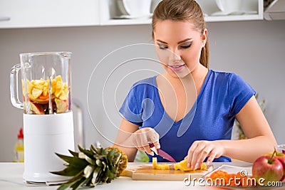 Healthy girl making fruits smoothies Stock Photo