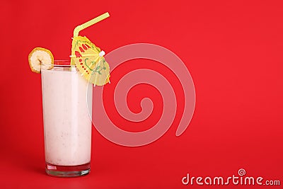 Healthy glass of smoothies banana flavor on red Stock Photo