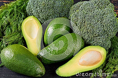 Healthy green food background with ingredients for veggie salad, diet dish. Fresh organic vegetables: avocado, dill and broccoli Stock Photo