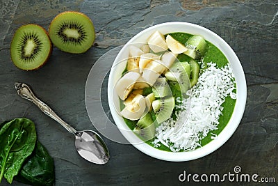 Healthy green smoothie bowl on slate Stock Photo