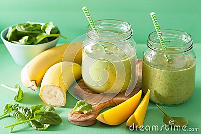 Healthy green smoothie with spinach mango banana in glass jars Stock Photo