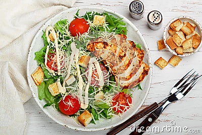 Healthy Grilled Chicken Caesar Salad with iceberg or lettuce, Cheese Parmesan, cherry tomatoes, bread Croutons and gourmet sauce Stock Photo