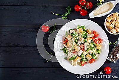 Healthy grilled chicken Caesar salad with tomatoes, cheese and croutons. Stock Photo