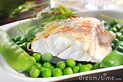 Healthy grilled fish steak with peas Stock Photo