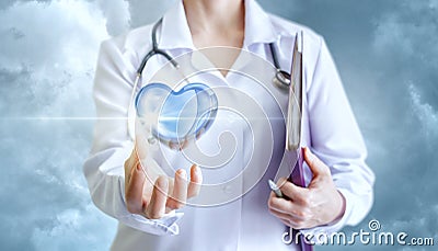 Healthy heart in the hand of the cardiologist. Stock Photo