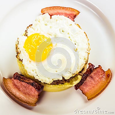 Healthy homemade breakfast. fried egg and meat patty on top of smashed potato, decorated with bacon. food isolated on the white Stock Photo