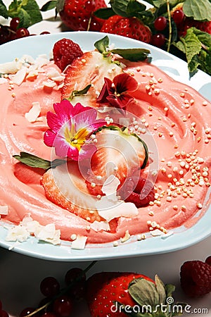 Healthy homemade raw vegan banana and berry ice cream icecream, nicecream topped with organic strawberries Stock Photo