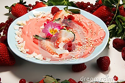 Healthy homemade raw vegan banana and berry ice cream icecream, nicecream topped with organic strawberries Stock Photo