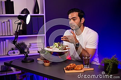 Healthy influencer in host channel taste chicken meat. Surmise. Stock Photo