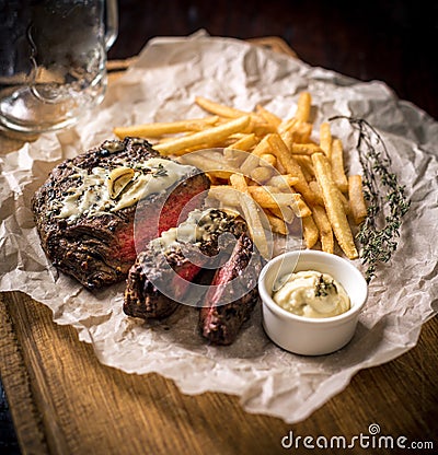 Healthy lean grilled medium-rare steak with french fries, beer Stock Photo