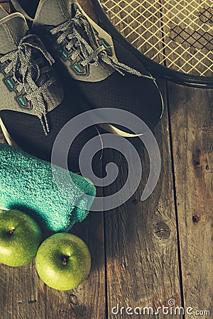 Healthy Life Sport Concept. Sneakers with Apples, Towel and Bottle of Water on Wooden Background. Copy Space. Stock Photo