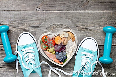 Healthy lifestyle concept with food in heart and sports fitness accessories Stock Photo