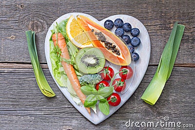 Healthy lifestyle with fresh fruits and vegetables on heart Stock Photo