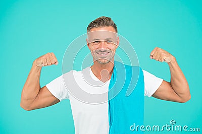 Healthy lifestyle. Gym wear and sports fashion for men. Gym aesthetics. Man well groomed athlete with towel on blue Stock Photo