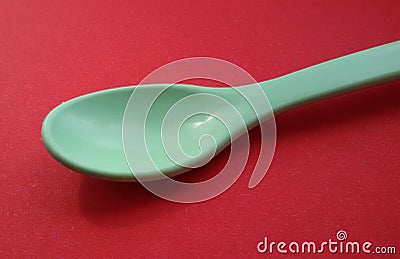 Spoon on red table. Symbolizing natural ingredients. Healthy food concept. Stock Photo