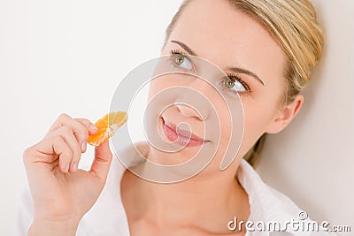 Healthy lifestyle - woman holding tangerine slice Stock Photo