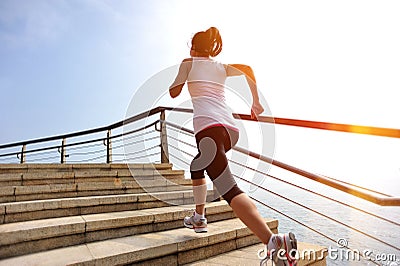 Healthy lifestyle woman legs running on stone stai Stock Photo