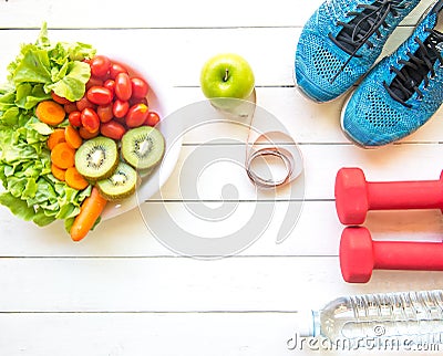 Healthy lifestyle for women diet with sport equipment, sneakers, measuring tape, vegetable fresh, green apples and bottle of water Stock Photo