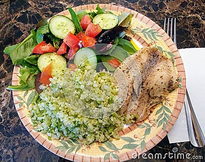 Tilapia, Cauliflower Rice and Side Salad - Low Carb Dinner Stock Photo