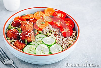 Healthy lunch bowl with quinoa, meatballs cucumbers, carrots and pumpkin seeds Stock Photo