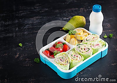 Healthy lunch box with tortilla wraps, tomatoes, banana. Stock Photo